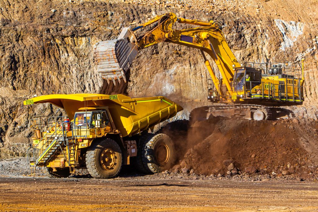digger loading dump truck with iron ore